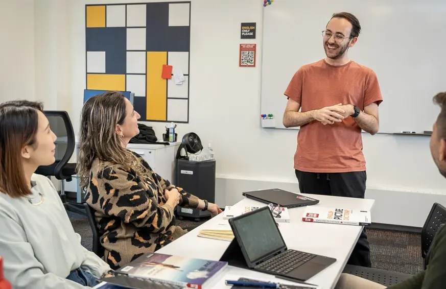 students having conversation with teacher